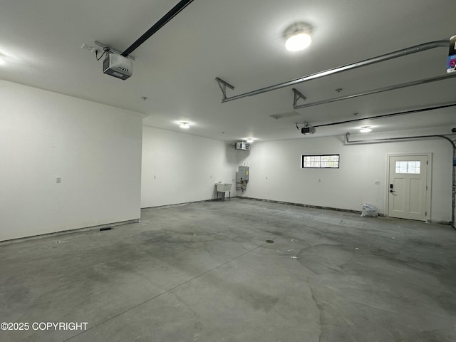 garage featuring water heater and a garage door opener