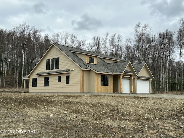 view of front of property with an attached garage and roof with shingles