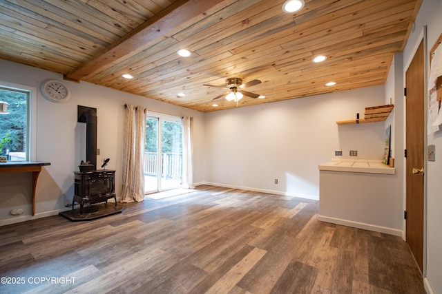 living area with a wood stove, wood ceiling, wood finished floors, and recessed lighting