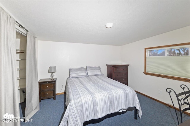 carpeted bedroom featuring a textured ceiling and baseboards