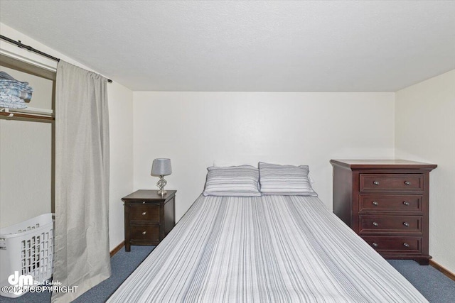 bedroom featuring carpet flooring and baseboards