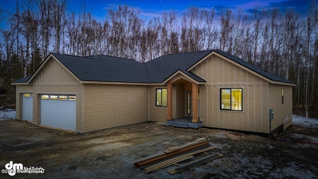 view of front of home featuring roof with shingles and an attached garage