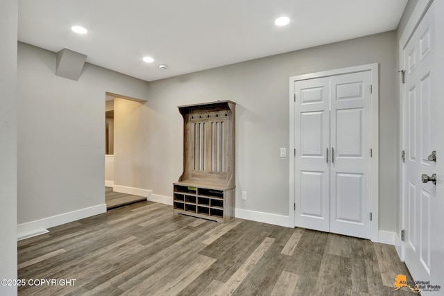 interior space featuring recessed lighting, wood finished floors, and baseboards