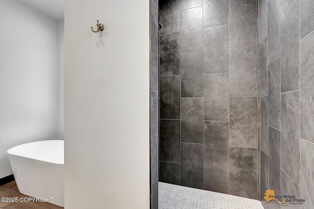 full bathroom featuring a freestanding tub and walk in shower