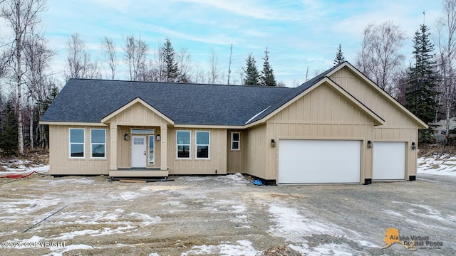 view of front of home with roof with shingles and an attached garage