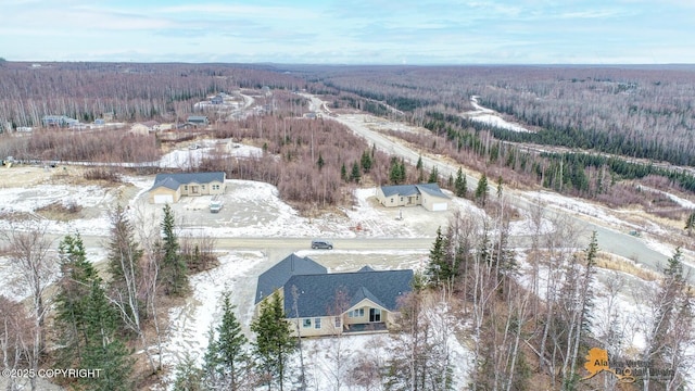 snowy aerial view featuring a view of trees