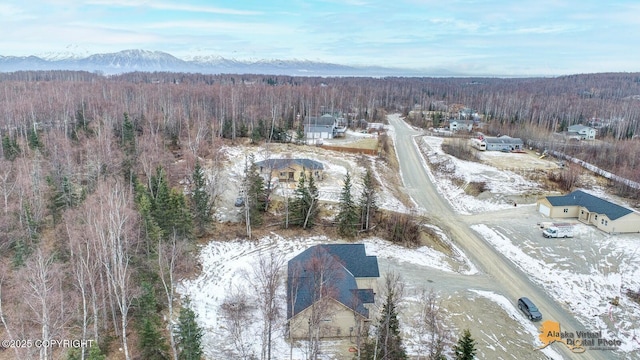 bird's eye view with a wooded view