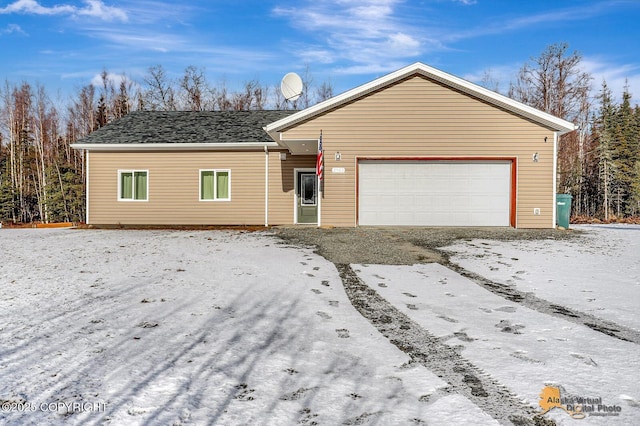 single story home with a garage and roof with shingles