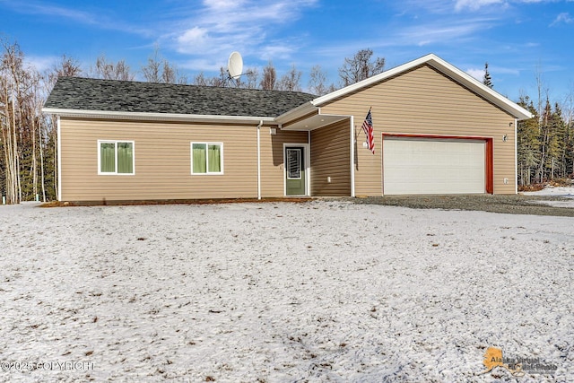 ranch-style home featuring roof with shingles and an attached garage