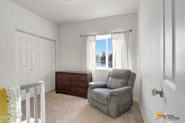 sitting room featuring baseboards and light colored carpet