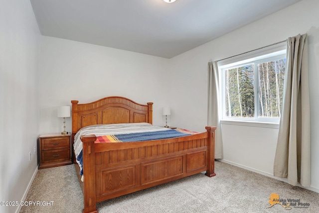 bedroom featuring light carpet and baseboards