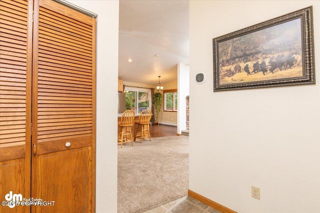 hallway with baseboards and carpet flooring