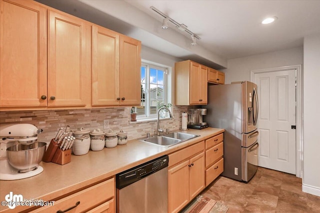 kitchen with tasteful backsplash, light countertops, light brown cabinetry, appliances with stainless steel finishes, and a sink