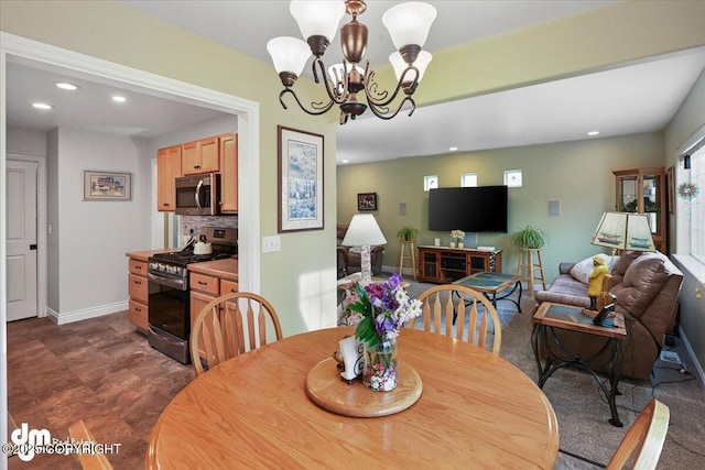 dining space with a chandelier, recessed lighting, and baseboards