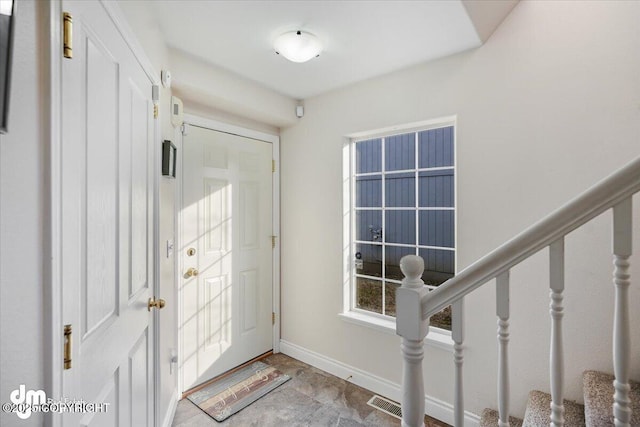 entrance foyer with stairway and baseboards