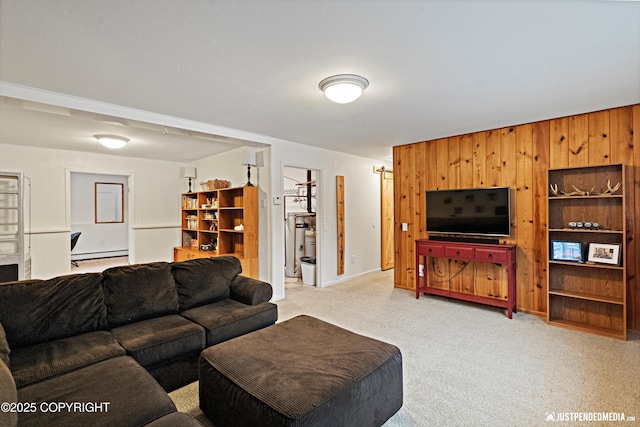 living room featuring a baseboard radiator, light colored carpet, and wooden walls