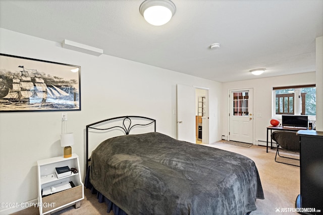 bedroom featuring light carpet, a baseboard radiator, and a baseboard heating unit