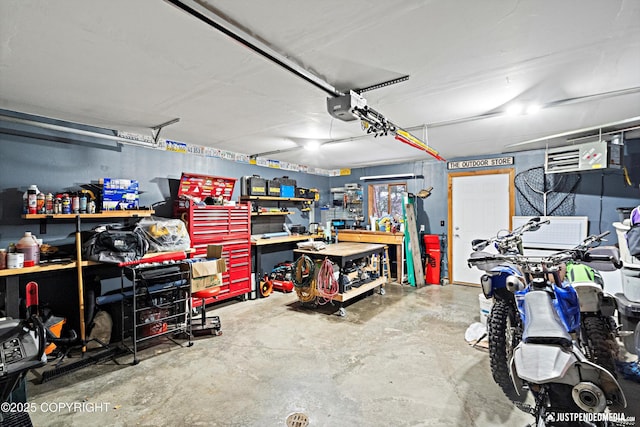 garage featuring a garage door opener and a workshop area