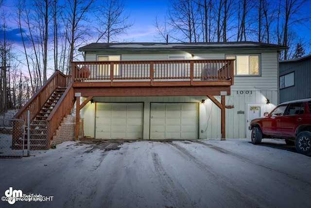 view of front facade featuring an attached garage and stairs