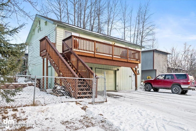 view of front facade featuring stairway, fence, and a deck