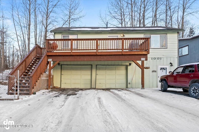 view of front of home with an attached garage and stairs