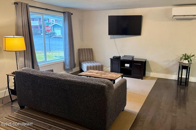 living room with a wall unit AC, baseboards, and wood finished floors