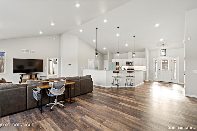 living room featuring baseboards, visible vents, dark wood-type flooring, high vaulted ceiling, and recessed lighting