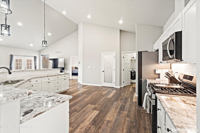 kitchen featuring a sink, white cabinets, appliances with stainless steel finishes, dark wood-style floors, and pendant lighting