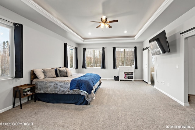 bedroom featuring recessed lighting, a raised ceiling, a barn door, carpet flooring, and baseboards