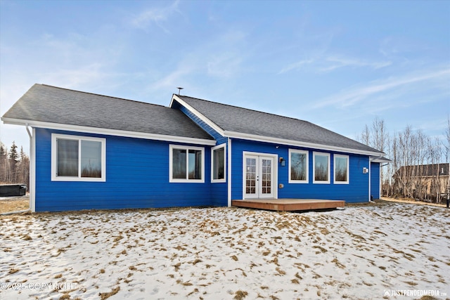 back of house featuring a wooden deck, roof with shingles, and french doors