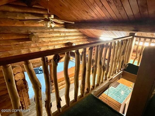 staircase with lofted ceiling with beams, rustic walls, and wood ceiling