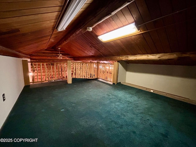 additional living space with dark carpet, wood ceiling, and vaulted ceiling with beams