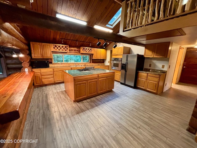 kitchen with tile countertops, wooden ceiling, light wood-style flooring, appliances with stainless steel finishes, and log walls