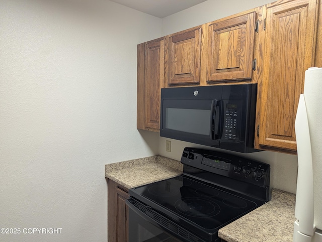 kitchen featuring black appliances, light countertops, and brown cabinets