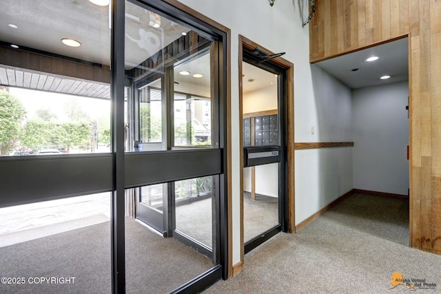 corridor featuring baseboards and carpet floors