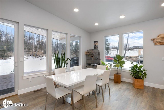 dining area with recessed lighting, lofted ceiling, visible vents, wood finished floors, and baseboards