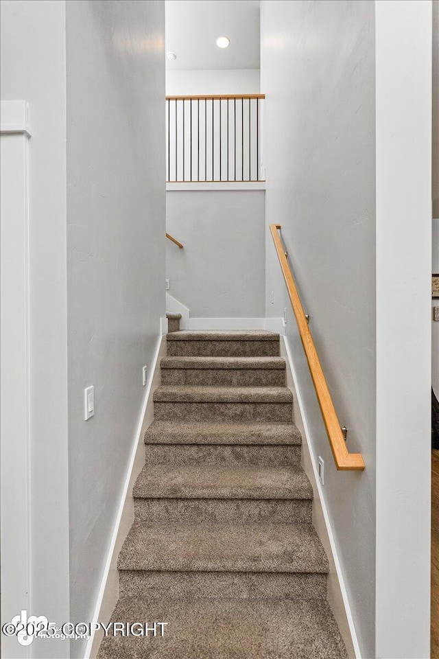 stairway with recessed lighting and baseboards