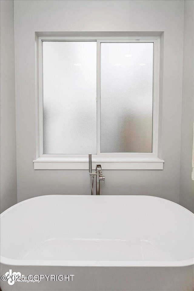 bathroom featuring a soaking tub