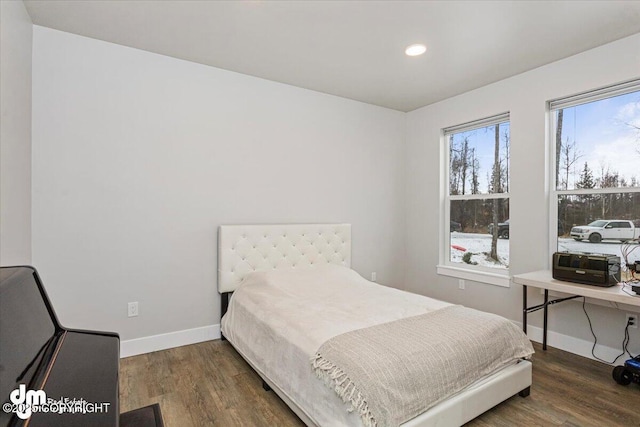 bedroom with recessed lighting, wood finished floors, and baseboards