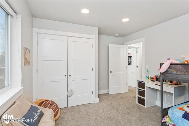 bedroom featuring recessed lighting, a closet, and light colored carpet