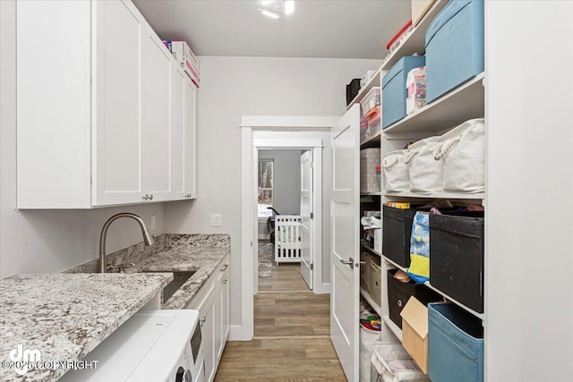 interior space with a sink and light wood finished floors