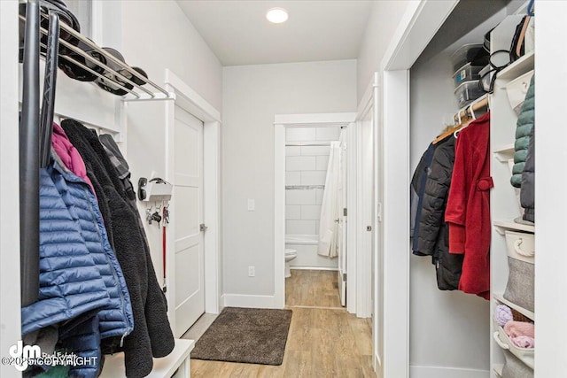 interior space with baseboards and wood finished floors