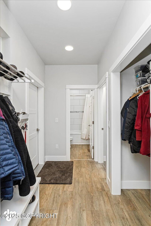 mudroom featuring baseboards and wood finished floors