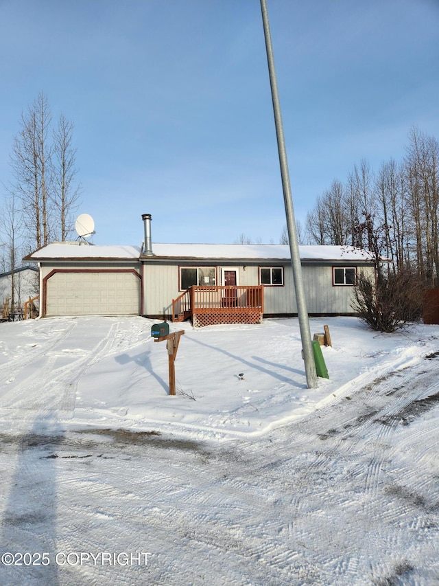 view of front of home featuring a garage and a wooden deck