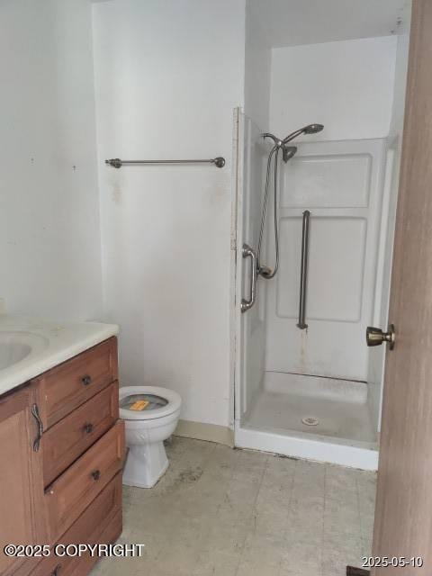 7811 Kiana Cir, Anchorage, AK 99507 - bathroom featuring a shower stall, vanity, toilet, and baseboards