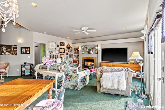 living area with carpet floors, recessed lighting, a tiled fireplace, and a ceiling fan