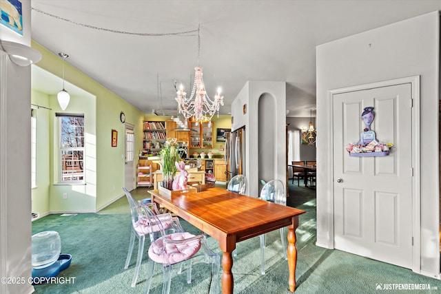 carpeted dining room with a notable chandelier