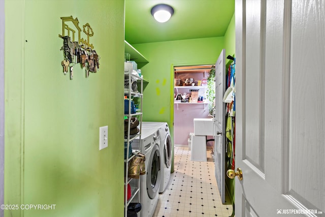 laundry area featuring laundry area, light floors, and washing machine and clothes dryer