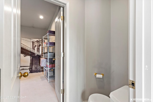 bathroom featuring recessed lighting and toilet