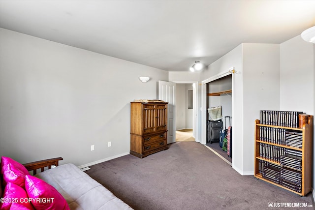 carpeted bedroom featuring a closet and baseboards